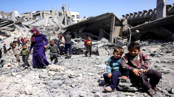 TOPSHOT - Children look on as people walk amid the rubble of a building destroyed in an overnight Israeli strike in Jabalia, in the northern Gaza Strip on March 18, 2025. Israel's deadly strikes on Gaza drew global condemnation on March 18, as it said it had "no alternative" other than to resume military operations in order to bring home hostages. (Photo by Bashar TALEB / AFP)